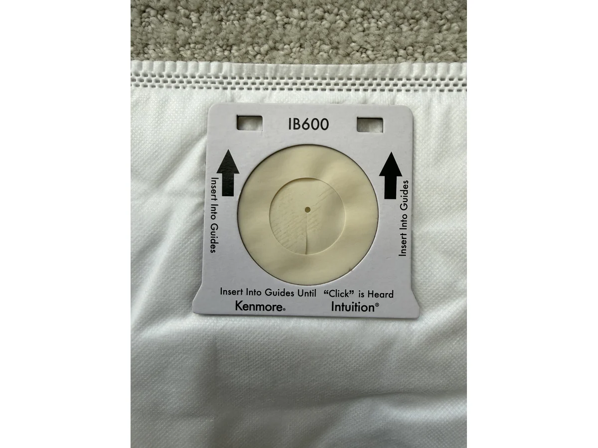 Kenmore IB600 Intuition No Touch vacuum bag collar close-up with IB600 label and guide arrows