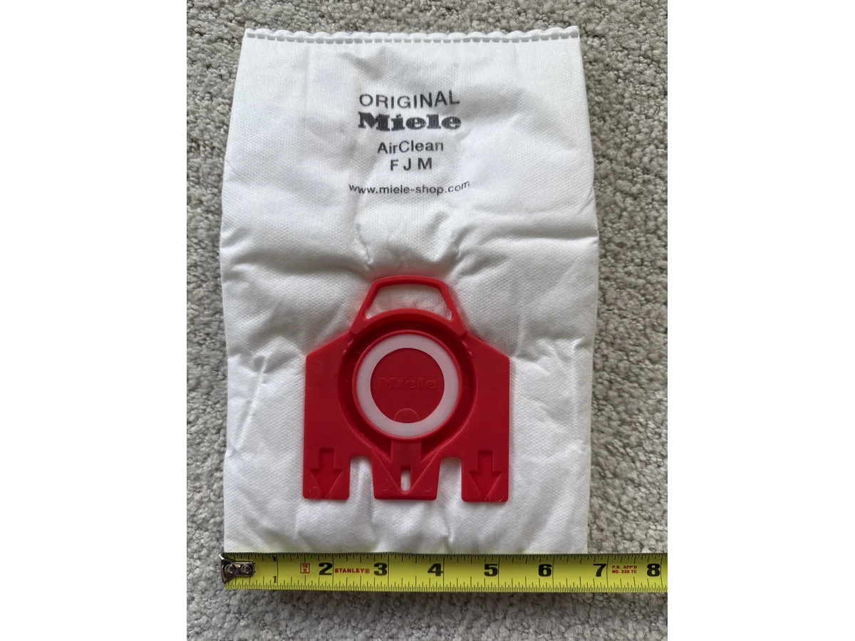 Miele FJM vacuum bag red collar and sealing ring photographed flat