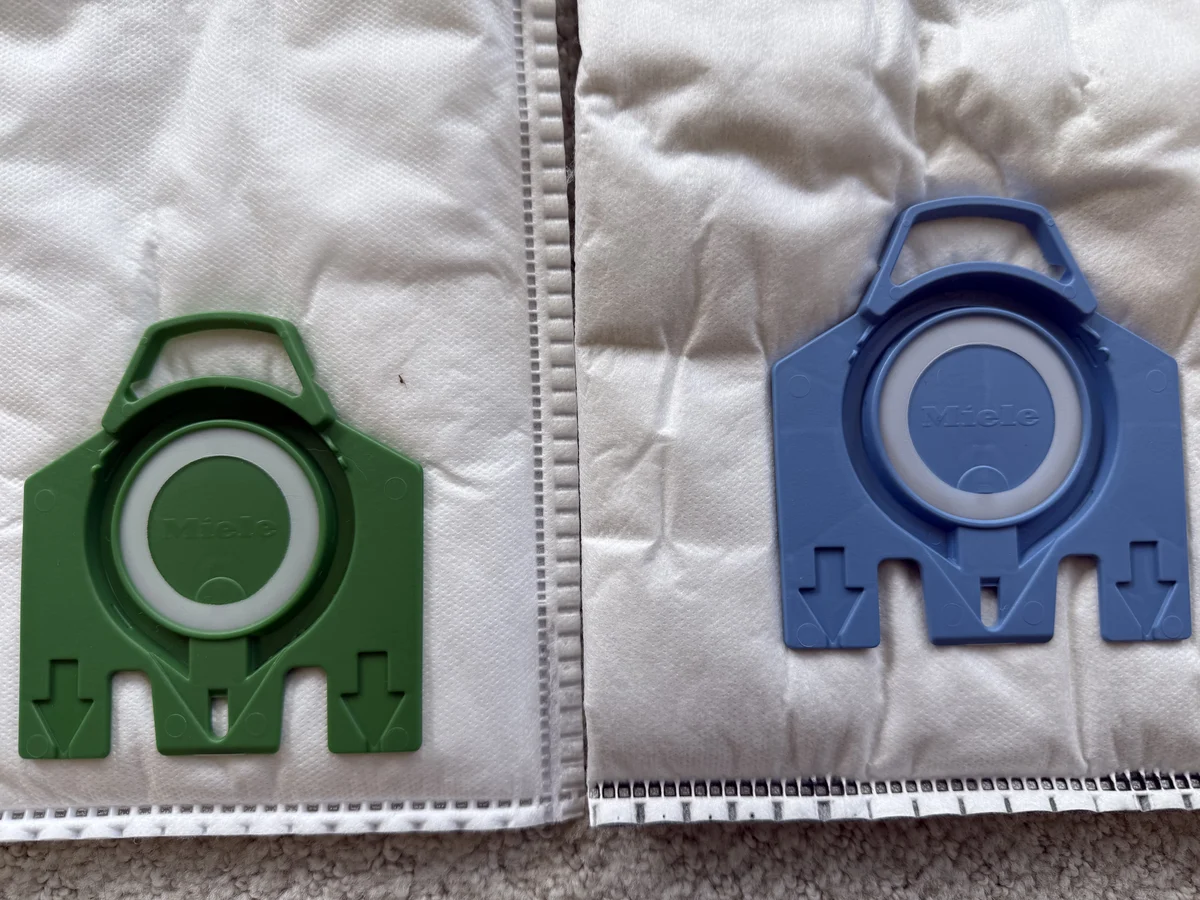 Miele GN blue collar beside Miele Type U green collar showing canister and upright bag differences